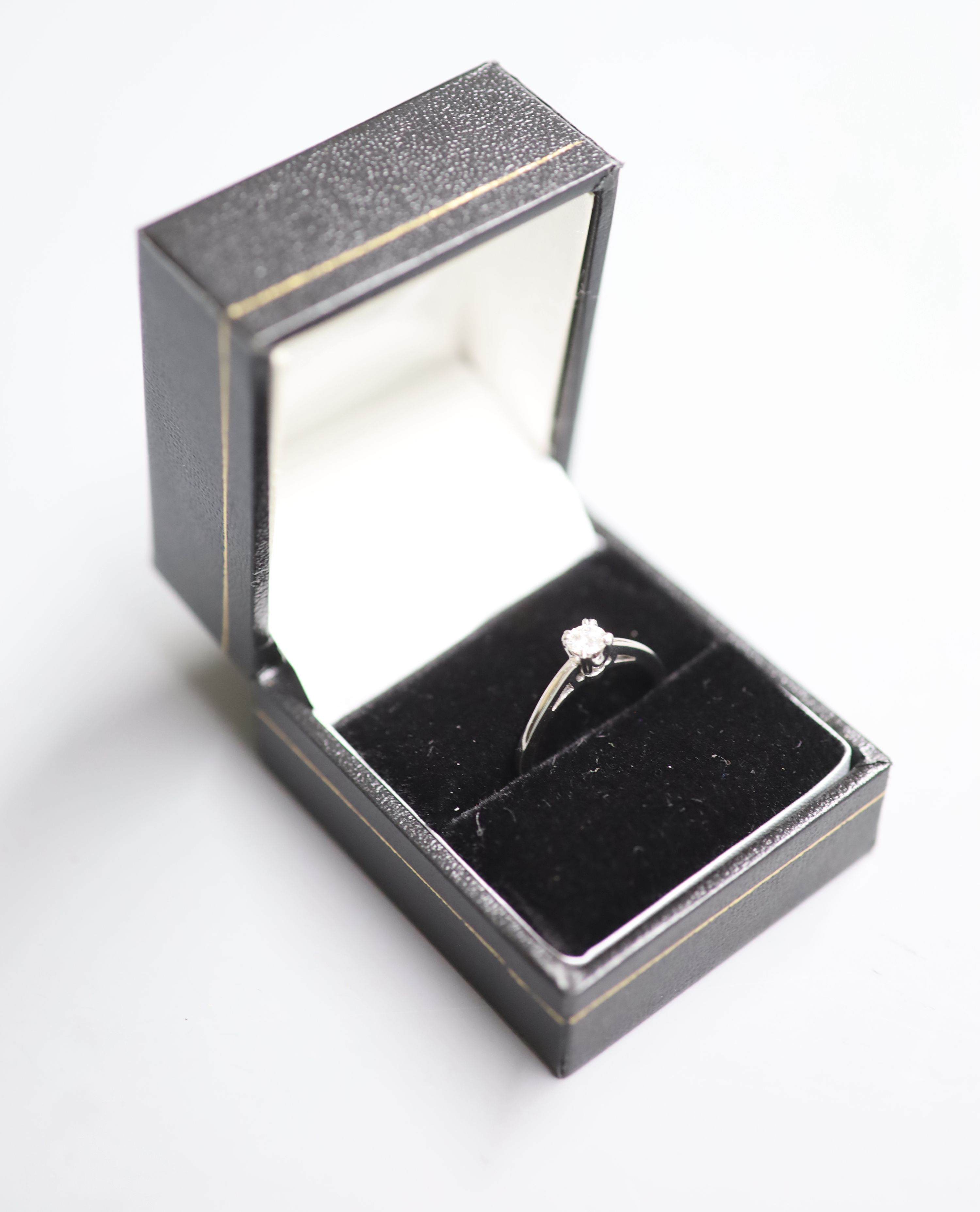 A modern white metal (stamped Plat) and solitaire diamond ring, size N, gross 4 grams,